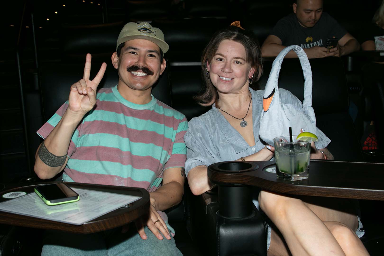 Audience members flashing the peace sign