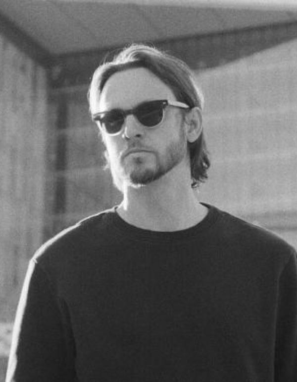 Matt Black looking in the distance, wearing sunglasses