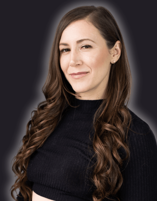 A woman with wavy hair smiles.