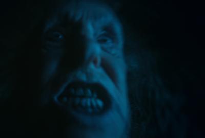 Creepy man looks on