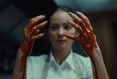 A woman looking at her bloody hands