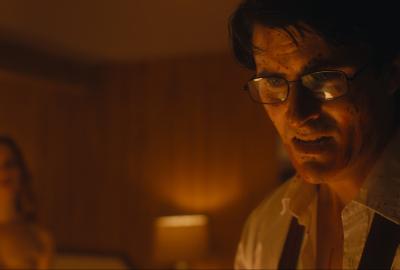 A distraught looking man with a female escort in the background