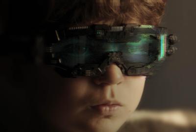 A young boy wearing strange augmented reality glasses. A glitch appears on them.