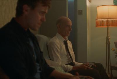 Man sits with his father on the sofa