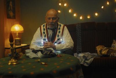 Older man sits at a table