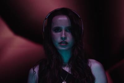 Sydney wearing headphones