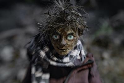 a young boy looks intently into our eyes