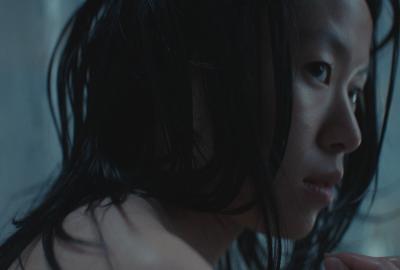 A shadowed close up of a girl's face in profile