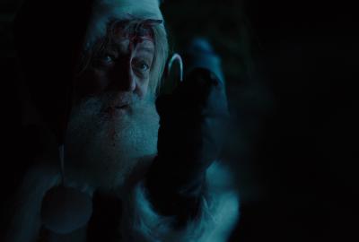 Santa looks at something he is holding 