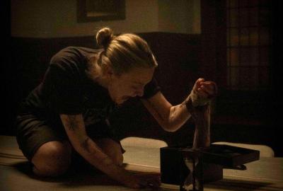  An arm shoots out of a box and grabs Polly (Dakota Fanning).