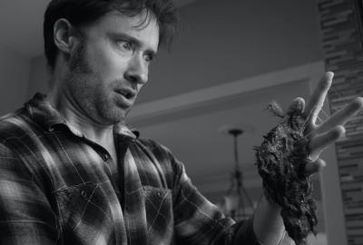 Dementia Part II man holds a dead rat