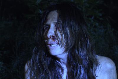 A horrified woman with bloodied face