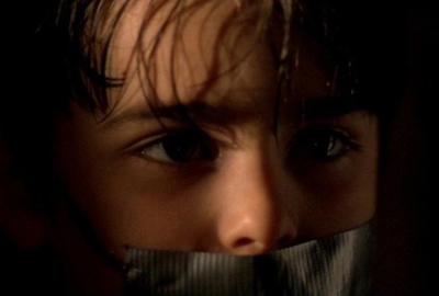 Malevolence boy with duct tape over his mouth