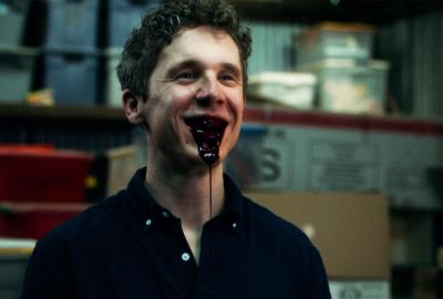 A man with blood pouring out of his mouth