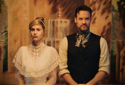 A man and woman stand next to each other in costume