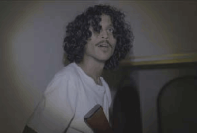 A male cousin holds a gun and looks on