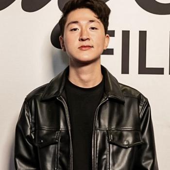 A man wearing a black leather jacket