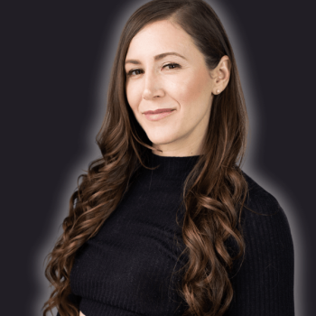 A woman with wavy hair smiles.