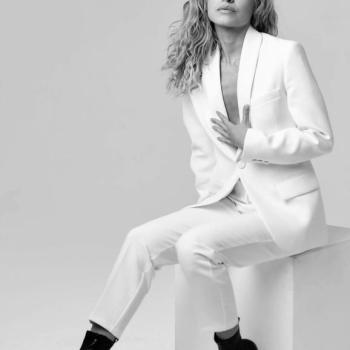 Meghan Carrasquillo in a Black-and-white photo wearing an all-white suit.