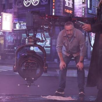 Director Jay Holben observes a setup beside a Technocrane and remote camera head on a smoky set